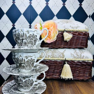 May include: A set of three ceramic mugs with a speckled, matte finish. The mugs are in shades of cream, light gray, and dark gray. Each mug has a simple, minimalist design, perfect for coffee or tea.