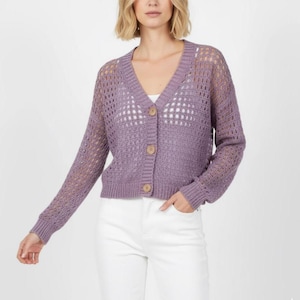 May include: A lavender-colored, open-weave cardigan with a V-neck and long sleeves. The cardigan has three wooden buttons down the front. The model is wearing a white top and white jeans.
