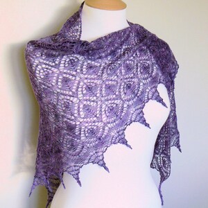 May include: A purple lace shawl with a delicate, intricate pattern. The shawl is draped over a white mannequin.