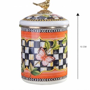 Bote esmaltado de 15 cm con diseño a cuadros, motivo de mariposa y remate de pájaro dorado.