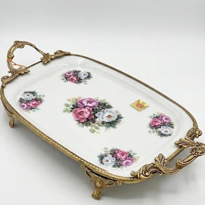 Vintage floral porcelain serving tray with ornate brass handles, pink roses and white flowers, footed rectangular table decor or gift