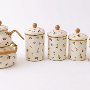 Vintage-Teeservice aus Emaille mit Blumenmuster, Holzknöpfen und Küchenbehältern