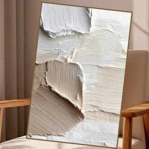 May include: A rectangular canvas featuring thick, impasto-style oil paint in shades of white, cream, and beige. The surface displays prominent, layered brushstrokes and palette knife marks that create a highly textured, three-dimensional appearance.