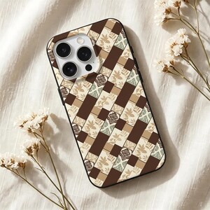 May include: A smartphone case featuring a geometric patchwork pattern of dark brown, cream, and sage green rectangles. The design includes alternating sections of solid colours, delicate leaf silhouettes, and intricate damask floral motifs.