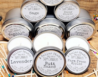 May include: A collection of small batch soy candles in silver tins. Scents include Honeysuckle Jasmine, Sage, Vanilla Bean, Happy Hippie, Coconut Lime, Lavender, Butt Naked, and Farm Fresh Apples. Each candle is labeled with its scent and size.