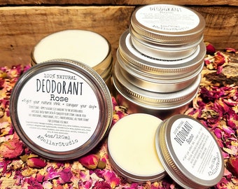 May include: A 4 ounce (120 ml) tin of natural rose deodorant. The tin is silver and has a white label with the text "100% Natural Deodorant Rose Fight your natural stink - conquer your day! 4oz/120ml ACellarStudio". The tin is surrounded by rose petals.