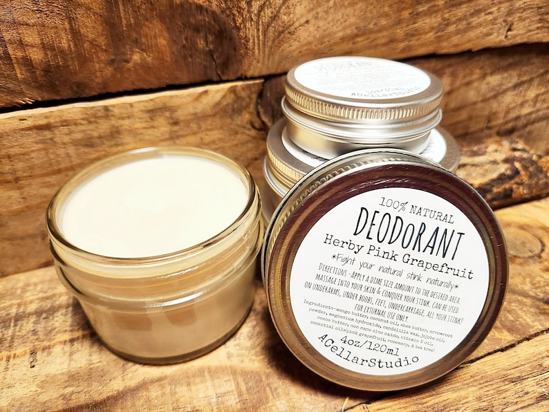 May include: A 4 ounce (120 ml) glass jar of natural deodorant with a white label that reads "100% Natural Deodorant Herby Pink Grapefruit *Fight your natural stink naturally* Directions: Apply a dime size amount to the desired area. Massage into your skin & conquer your stink. Can be used on underarms, under boobs, feet, undercarriage, all your stink! For external use only. Ingredients: Magnesium hydroxide,  sodium bicarbonate, arrowroot powder, shea butter, coconut oil, zinc oxide, jojoba oil, essential oils: pink grapefruit, rosemary, cedar & tea tree. 4oz/120ml ACellarStudio"