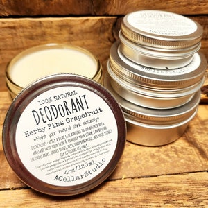 May include: A silver tin of natural deodorant with a white label that reads "100% Natural Deodorant Herby Pink Grapefruit *Fight your natural stink naturally* Directions: Apply a dime size amount to the desired area. Massage into your skin & conquer your stink. Can be used on underarms, under boobs, feet, undercarriage, all your stink? For external use only. Ingredients: mango butter, coconut oil, beeswax, arrowroot powder, shea butter, kaolin clay, vitamin E oil, essential oils, witch hazel, rosemary & tea tree oil. 4oz/120ml 4CellarStudio"