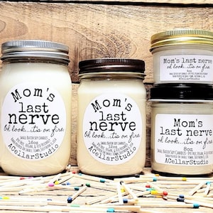 May include: Three glass jars with white soy candles. Each jar has a black and white label that reads "Mom's last nerve Oh look...it's on fire." The labels also include the size of the candle in ounces and the brand name "ACellarStudio".