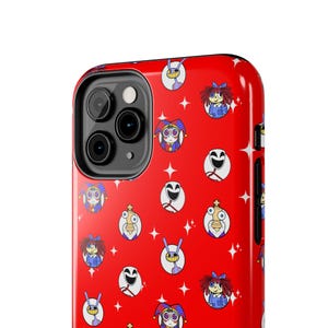 May include: Red phone case with a repeating pattern of cartoon characters in various designs. The case features a camera cutout and a glossy finish. The characters include jesters, dolls, and other whimsical figures.