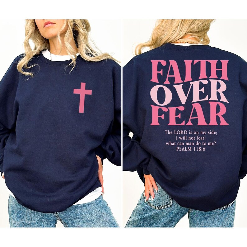 May include: Navy blue sweatshirt with a pink cross on the front and the words "FAITH OVER FEAR" on the back. The text "The LORD is on my side; I will not fear: what can man do to me? PSALM 118:6" is below the main text.