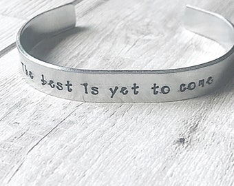 May include: Silver bracelet with the inscription "The best is yet to come".