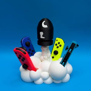 Soporte Joy-Con Cloud & Missile – Base para mando de videojuegos – Compatible con Nintendo Switch – Decoración para gamers – Soporte original para mando