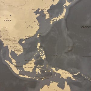 May include: A detailed map of East Asia and the Pacific Ocean, featuring countries like China, Japan, and Australia. The map is in shades of beige and gray, with country names and geographical features clearly labeled. The Pacific Ocean is labeled.
