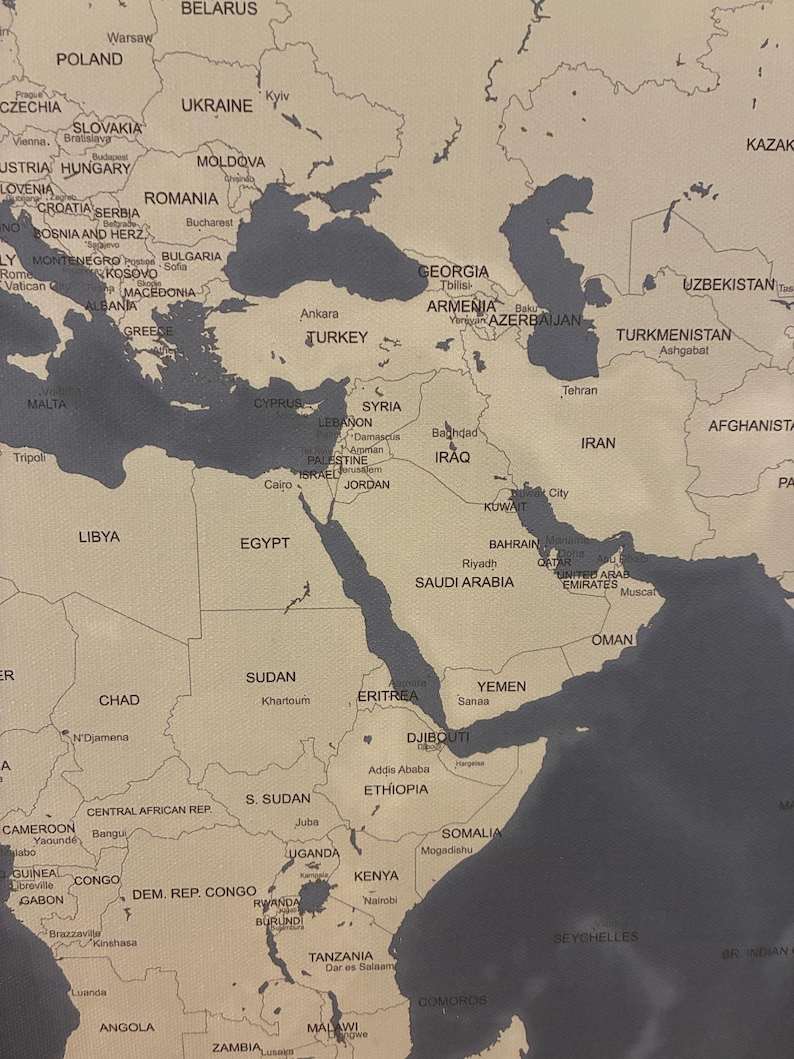 May include: A detailed world map with a neutral color palette, featuring countries and cities labeled in a clear font. The map highlights regions with a dark gray color, contrasting with the beige background. The image is a close-up of the Middle East and surrounding areas.