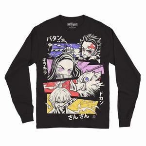 May include: Black long-sleeve shirt featuring a colorful graphic design with Japanese text and anime-style characters. The design includes multiple panels with different characters and action poses.