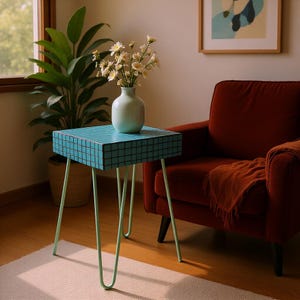 May include: A small, square side table with a turquoise tiled top and mint green hairpin legs. A white vase with flowers sits on the table. The table is next to a red armchair and a potted plant.
