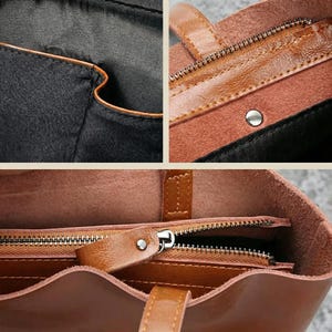 Op de afbeelding: Close-up van een bruine leren tote bag. De tas heeft een ritssluiting, een bruine leren handgreep en een zwart interieur. De stiksels en details van de tas zijn zichtbaar en tonen het vakmanschap.