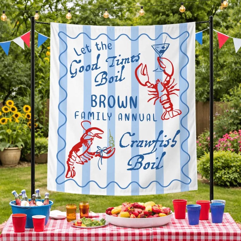 May include: A white banner with blue vertical stripes and a wavy blue border. The banner reads "Let the Good Times Boil BROWN FAMILY ANNUAL Crawfish Boil" with red crawfish illustrations and a cocktail glass.