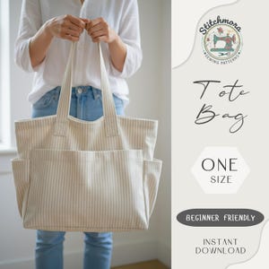 May include: Cream-coloured tote bag with vertical stripes, held by a person. The bag has two exterior pockets and long handles. Text on the image reads "Tote Bag", "One Size", "Beginner Friendly", and "Instant Download".