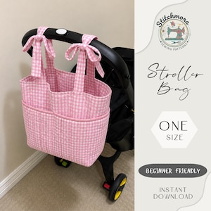 May include: A pink and white gingham stroller bag featuring two exterior pockets and two top handles that tie onto a black stroller frame. The image includes text: Stitchmora Sewing Patterns, Stroller Bag, One Size, Beginner Friendly, Instant Download.
