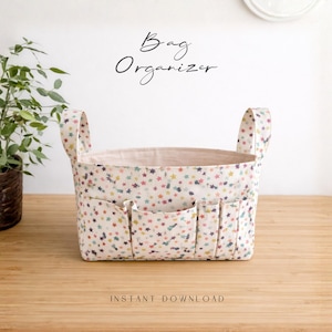 May include: A fabric bag organiser with a star pattern in various colours. The bag has multiple pockets on the front and two handles. Text on the image reads "Bag Organizer" and "Instant Download".