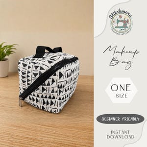May include: A quilted makeup bag featuring a black and white geometric pattern with triangles and lines. The bag has a black zipper closure and a top handle. Text on the right side reads Stitchmora Sewing Patterns, Makeup Bag, ONE SIZE, BEGINNER FRIENDLY, INSTANT DOWNLOAD.