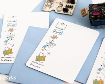 May include: Three white cards with blue envelopes. Each card features a different science-themed illustration, including a beaker, a seesaw, an atom, and the equation E=mc². The cards have the text "From the desk of Dr. Grace" at the bottom.