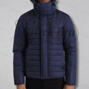 May include: A navy blue quilted jacket with a high collar and a zipper closure. The jacket has a subtle sheen and a streamlined design. The text "Stitch Era Boutique" is visible on the jacket.