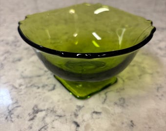 Vintage olive green Indiana glass serving bowl with ruffled rim and square pedestal base.