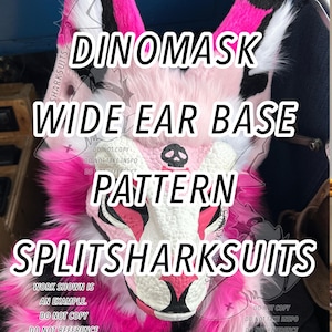 May include: A close-up of a Dinomask wide ear base pattern. The mask features a white face with pink and black accents, and vibrant pink fur. The text "DINOMASK WIDE EAR BASE PATTERN SPLITSHARKSUITS" is displayed.