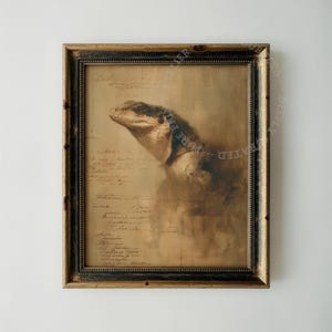 May include: A framed wall art piece featuring a sepia-toned illustration of a lizard head superimposed over handwritten cursive script. The artwork is enclosed in a dark, distressed wooden frame with gold-toned inner detailing and a beaded edge.