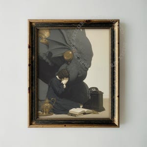 May include: A framed print featuring a person in a dark robe kneeling with hands covering their face before a large, shadowy, winged creature. A gold teapot, an open book, and a small black box are placed on the floor in front of them.