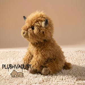 Fluffy brown Highland cow plushie sitting on a soft rug. Cute Scottish cow stuffed animal with long shaggy hair and horns.