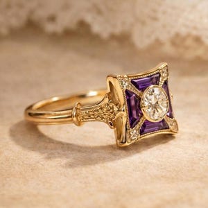 May include: A gold ring with a square, Art Deco-inspired design. The ring features a central round diamond, surrounded by purple gemstones and smaller diamonds. The band has intricate detailing.