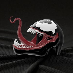May include: A black and white Venom bust with a red tongue and mouth. The bust features sharp white teeth and a white patch on the head. The sculpture is set against a dark background.
