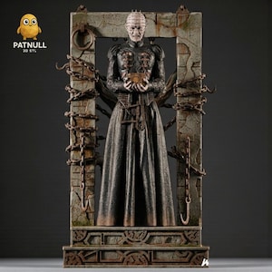 May include: A detailed statue of a character from the horror film Hellraiser, standing within a stone archway. The figure is dressed in a long black robe and holds a small box. Rusty chains hang from the arch. The text "PATNULL 3D STL" is visible.