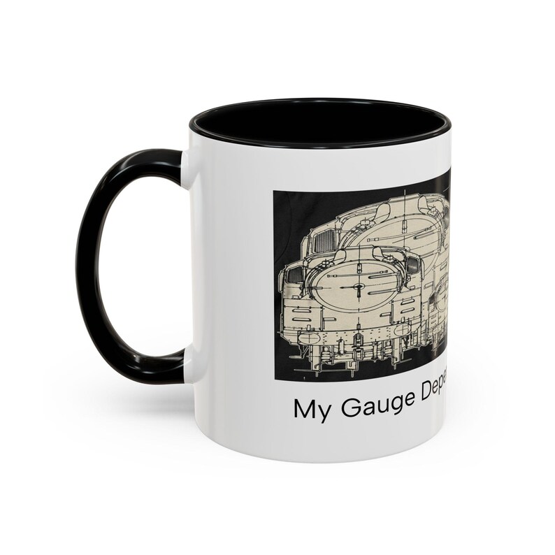 May include: A white ceramic mug with a black interior and handle, featuring a black and white technical line drawing of a steam locomotive on the side. Below the illustration, the text reads My Gauge Depends on You in black font.