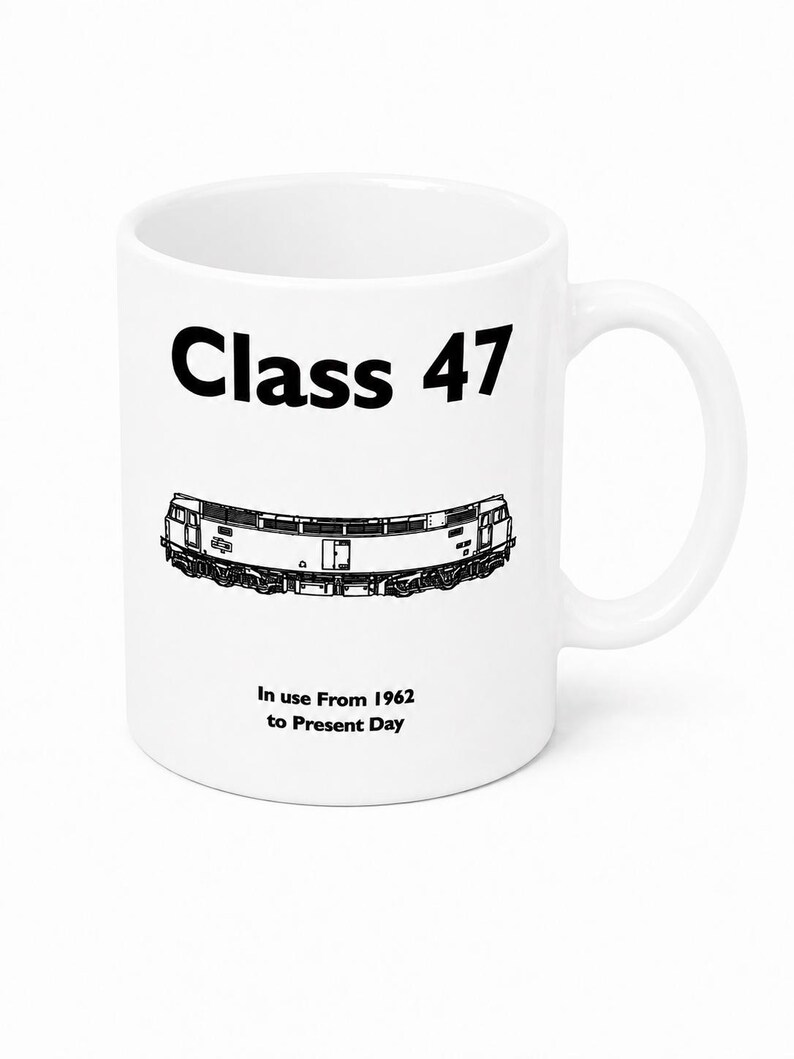 May include: A white ceramic mug featuring a black graphic illustration of a Class 47 locomotive. The text "Class 47" is printed in bold black letters above the train, and the text "In use From 1962 to Present Day" is printed below the train.