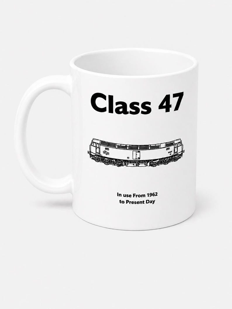 May include: A white ceramic mug featuring a black graphic illustration of a Class 47 locomotive. The text "Class 47" appears in bold black letters above the train, with the text "In use From 1962 to Present Day" printed in black below the train.