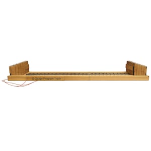 May include: A wooden O Gauge Program Track with a section of train tracks. The track has two wooden end pieces and the text "O Gauge Program Track" printed on the side. A red wire extends from the track.