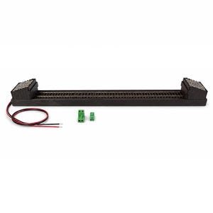 May include: A model train track section featuring a straight rail bed with black buffers at both ends, topped with textured gray ballast. The assembly includes a red and black power wire lead and two small green electrical terminal connectors.