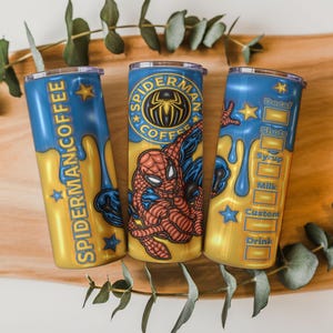 May include: Three custom coffee tumblers with a Spider-Man theme. The tumblers are blue and gold, with the words "Spider-Man Coffee" and a Spider-Man logo. One tumbler has a drink customization menu.