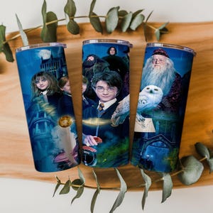 May include: Three stainless steel tumblers with blue backgrounds and images of characters from the Harry Potter film series. The tumblers feature images of Hermione, Harry, Dumbledore, and other characters.