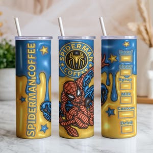 May include: Three insulated stainless steel tumblers with lids and straws. Each tumbler features a design with the text "SPIDERMAN COFFEE" and a Spider-Man graphic. The tumblers have a blue and gold colour scheme.