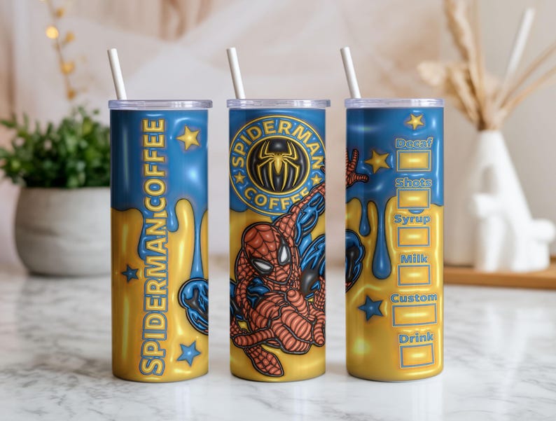 May include: Three insulated stainless steel tumblers with lids and straws. Each tumbler features a design with the text "SPIDERMAN COFFEE" and a Spider-Man graphic. The tumblers have a blue and gold colour scheme.