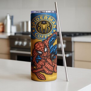 May include: A stainless steel tumbler with a Spider-Man design. The tumbler has a yellow and blue background with the words "Spider-Man Coffee" and a graphic of Spider-Man. A silver straw is next to the tumbler.
