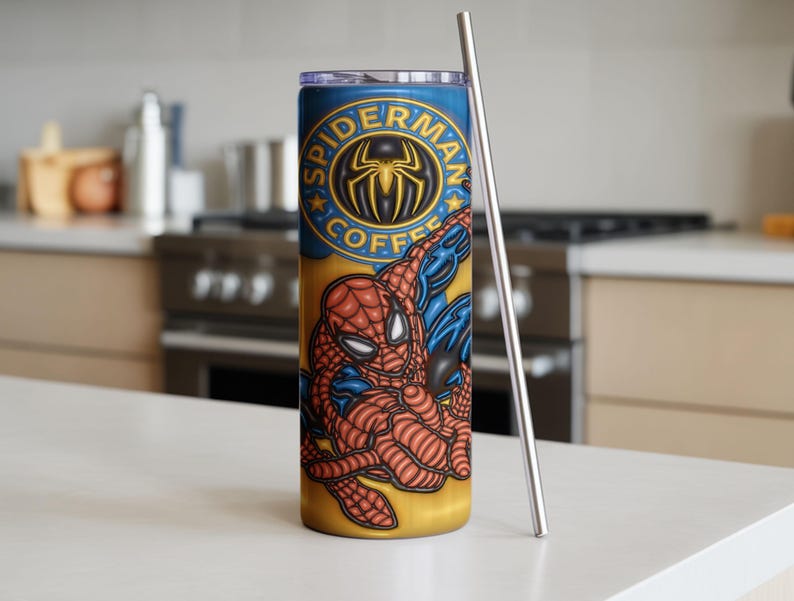 May include: A stainless steel tumbler with a Spider-Man design. The tumbler has a yellow and blue background with the words "Spider-Man Coffee" and a graphic of Spider-Man. A silver straw is next to the tumbler.