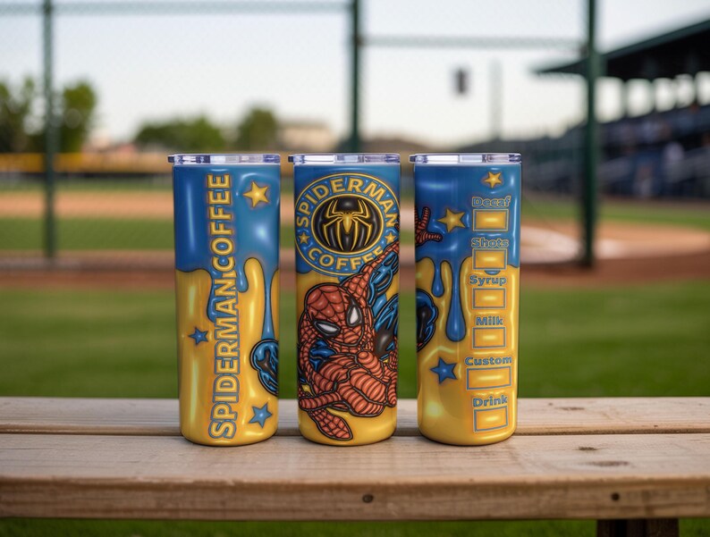 May include: Three stainless steel tumblers with a Spider-Man theme. The tumblers are yellow and blue with the words "Spider-Man Coffee" and a Spider-Man graphic. One tumbler has a coffee order form.