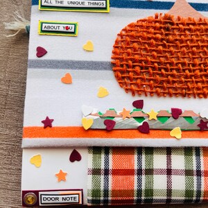 May include: A fabric door note featuring a burlap pumpkin, horizontal stripes, and scattered heart and star cutouts. Text labels read FALLING FOR, ALL THE UNIQUE THINGS, ABOUT YOU, and DOOR NOTE. The base includes a plaid pattern in orange and green.